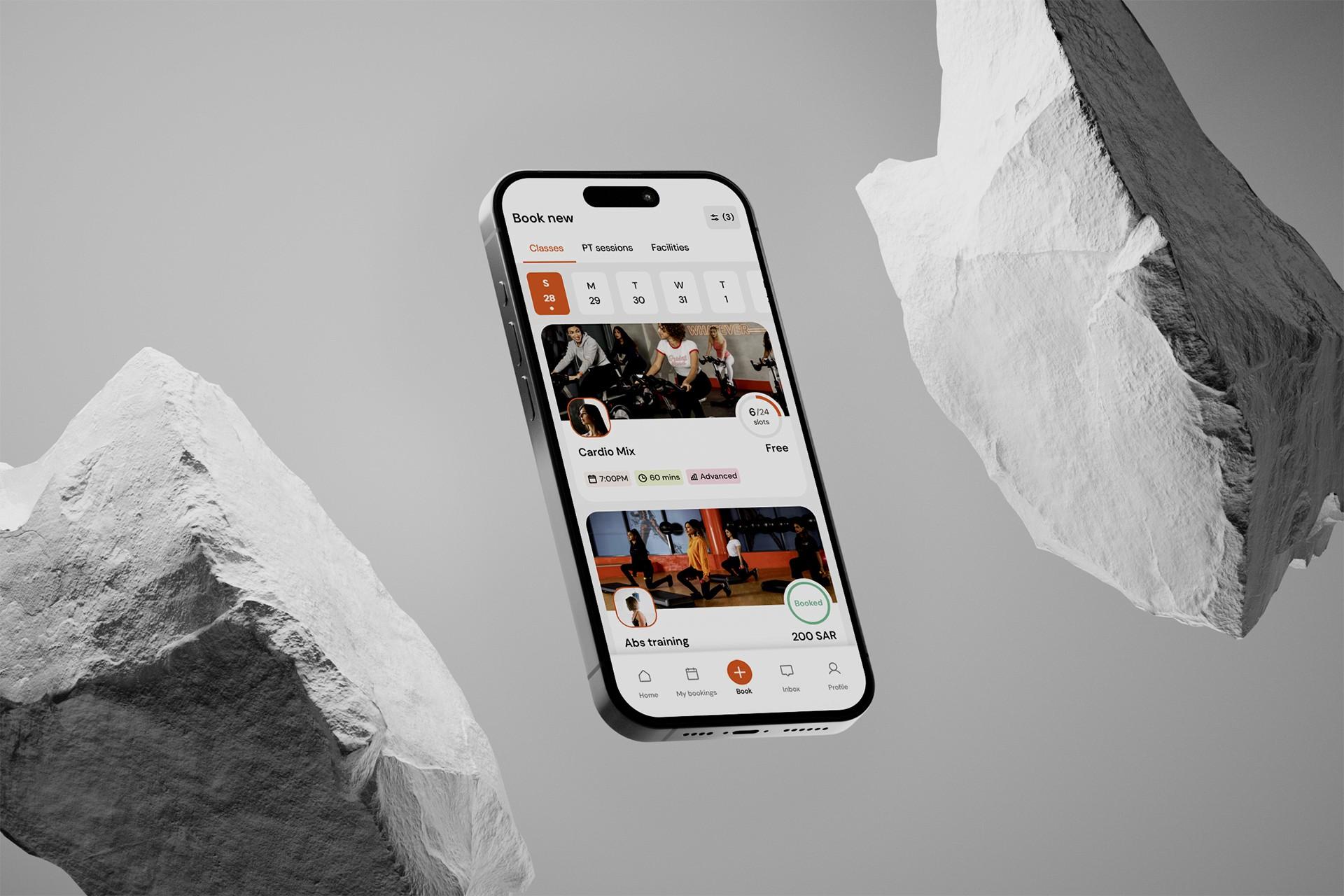 KUN mobile booking app floating between grey rock forms.